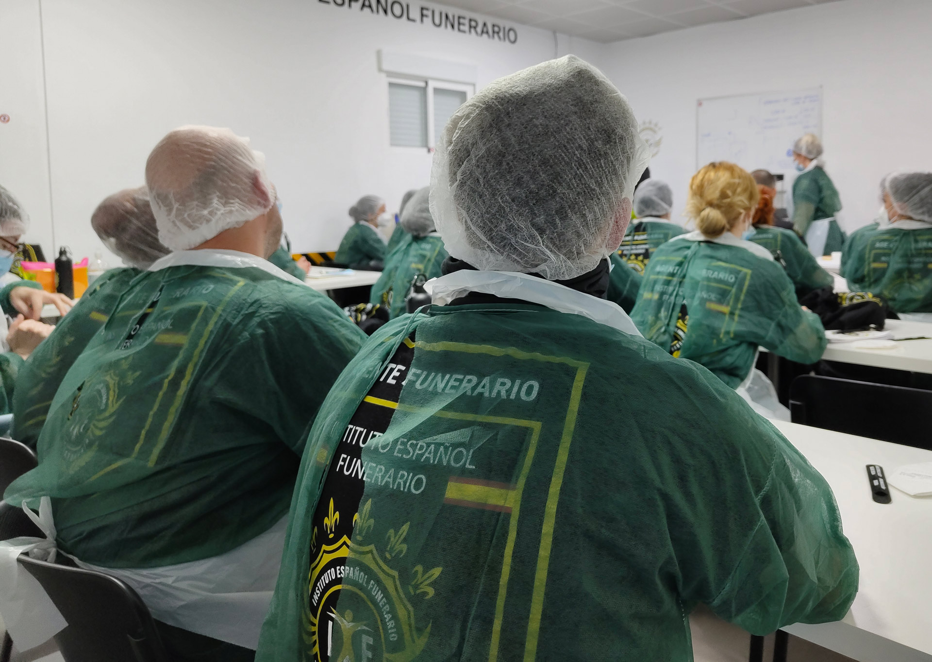 Profesor enseñando técnicas de tanatoestética a un alumno